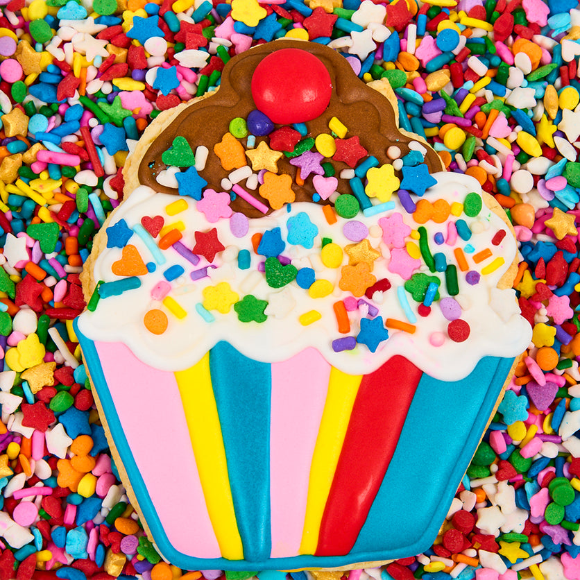 sprinkle-background-with-cookie-shaped-like-a-cupcake-on-top